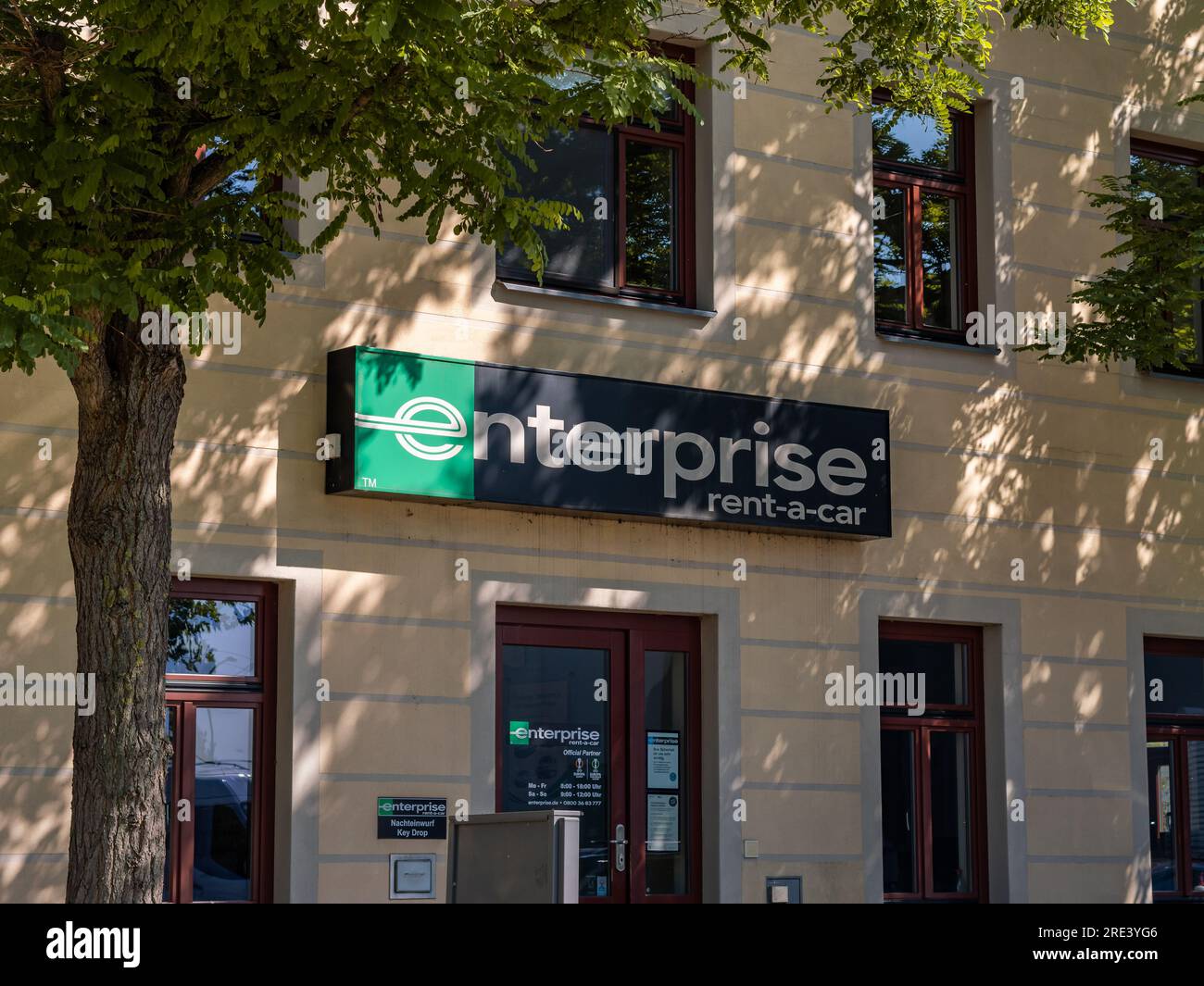 Enterprise car rental agency logo sign on a building exterior. Entrance