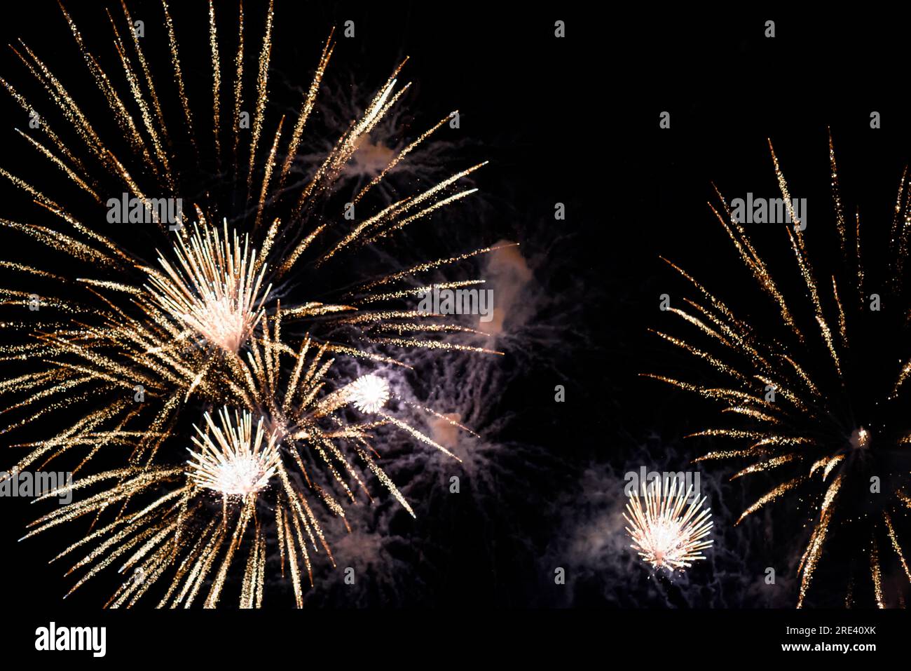 Close-up fireworks explode in the sky with motion blur on a black background. Stock Photo