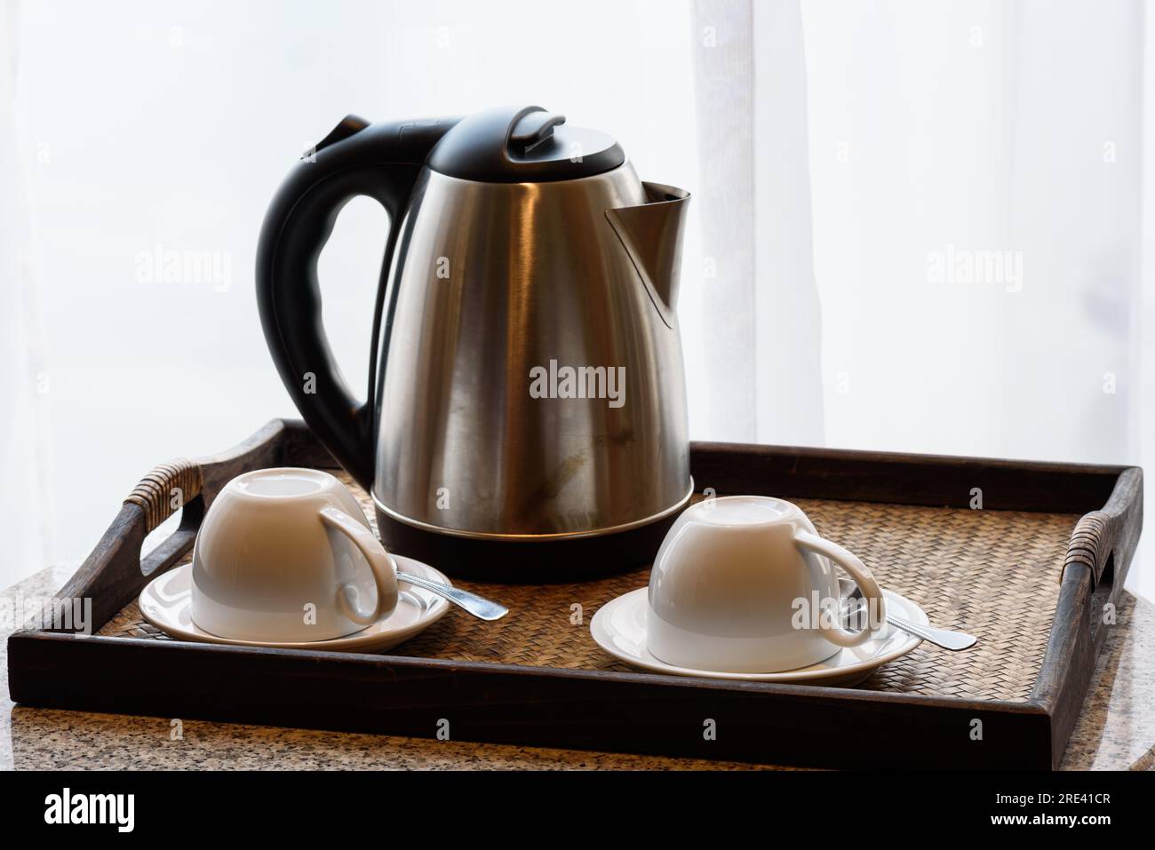 https://c8.alamy.com/comp/2RE41CR/electric-kettle-and-coffee-cup-set-in-hotel-room-ceramic-cup-set-2RE41CR.jpg