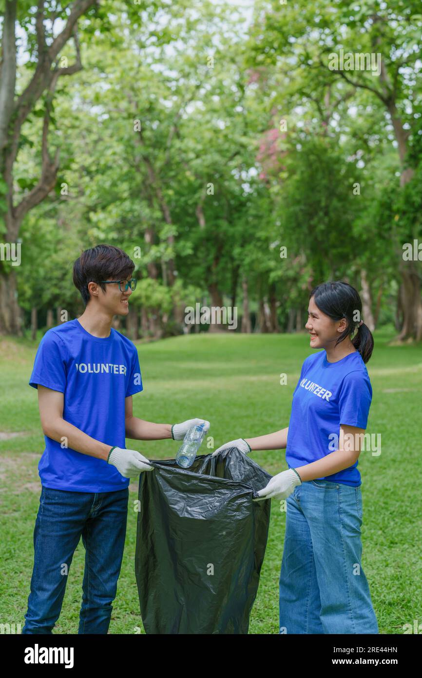 Multiethnic volunteers donate their time holding black garbage bags to