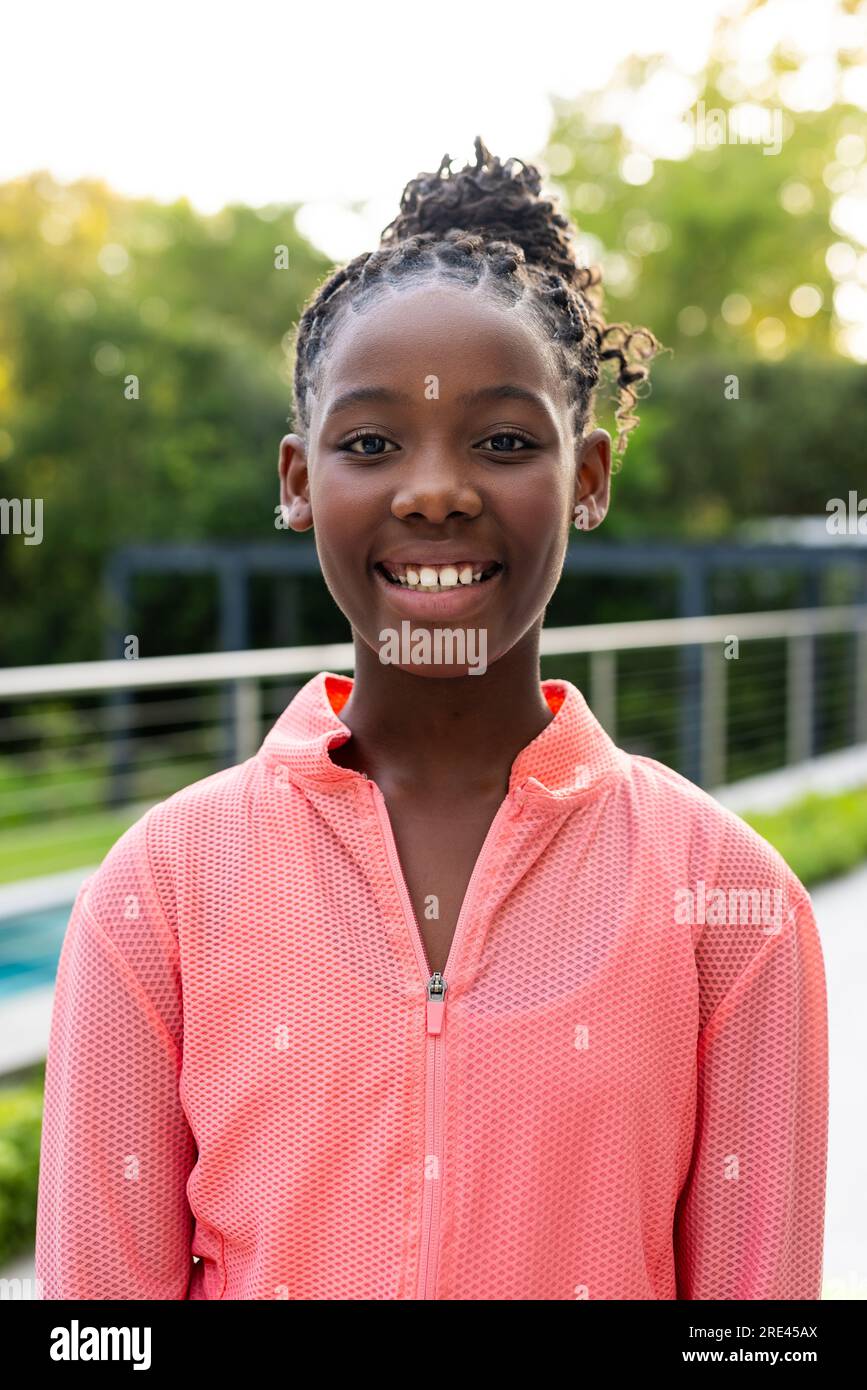 Portrait of happy african american girl on sunny terrace at home Stock ...