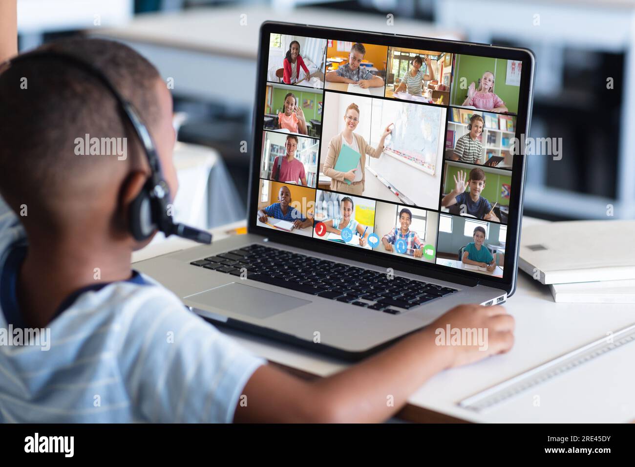 African american boy having a video conference with female teacher and ...