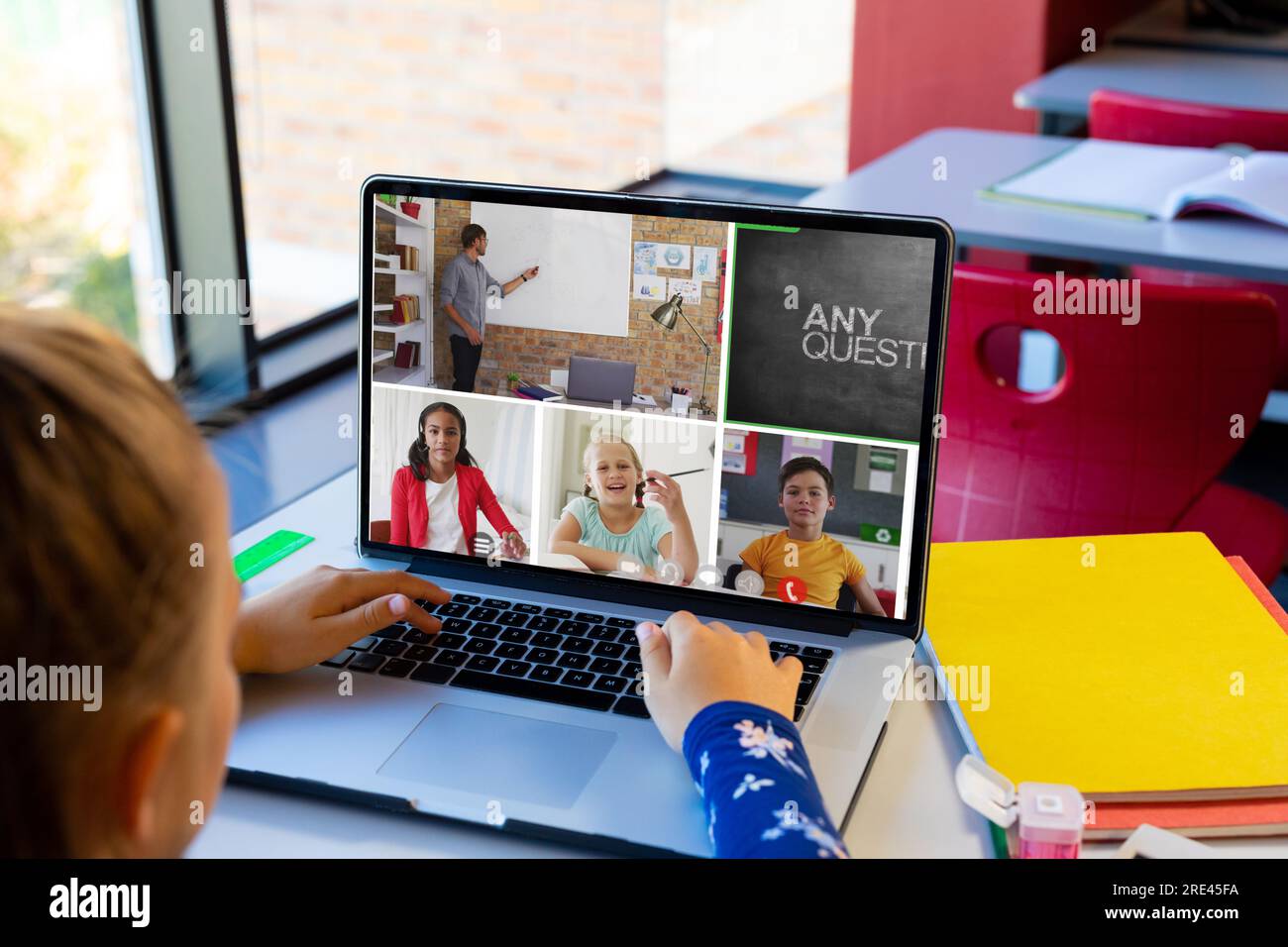 Caucasian girl having a video conference with male teacher and diverse ...