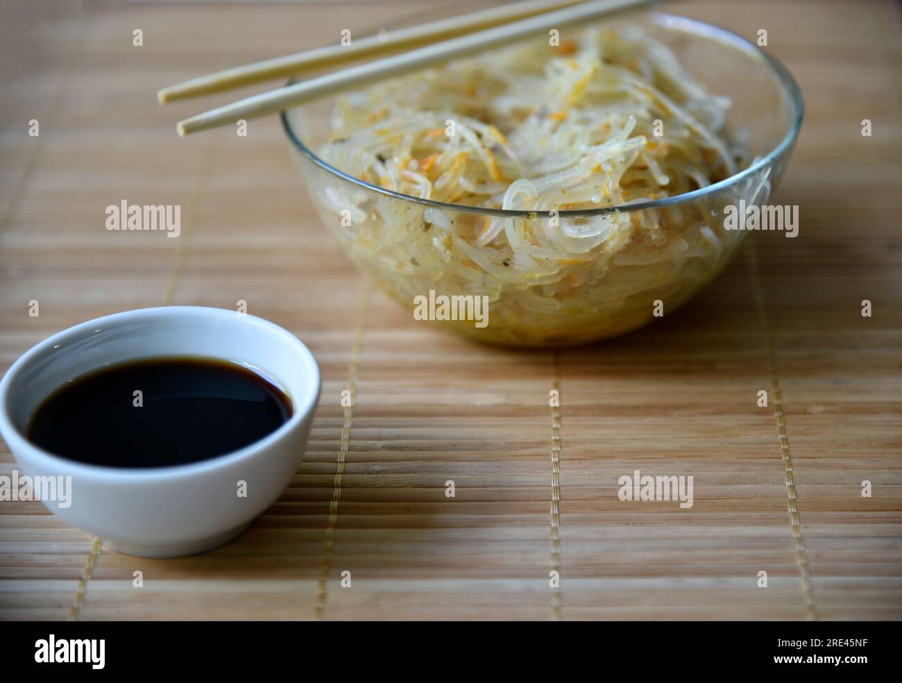 Korean rice noodles with meat and spices in a glass bowl. Delicious