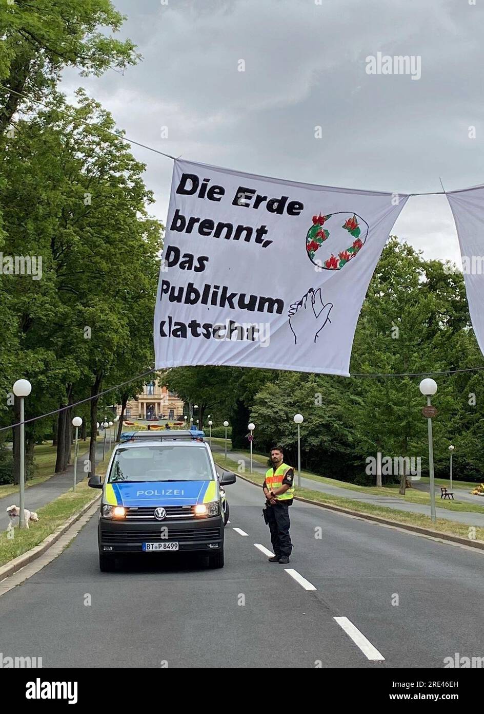  Bayreuth, Germany. 25th July, 2023. A banner reading "The earth burns Illustration 