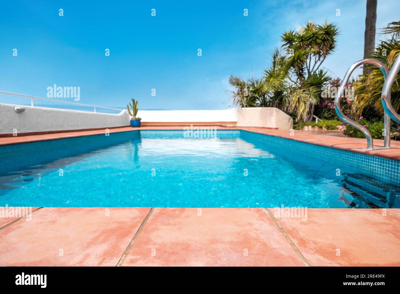 Terracotta tile closeup, tiled terrace with pool background Stock Photo