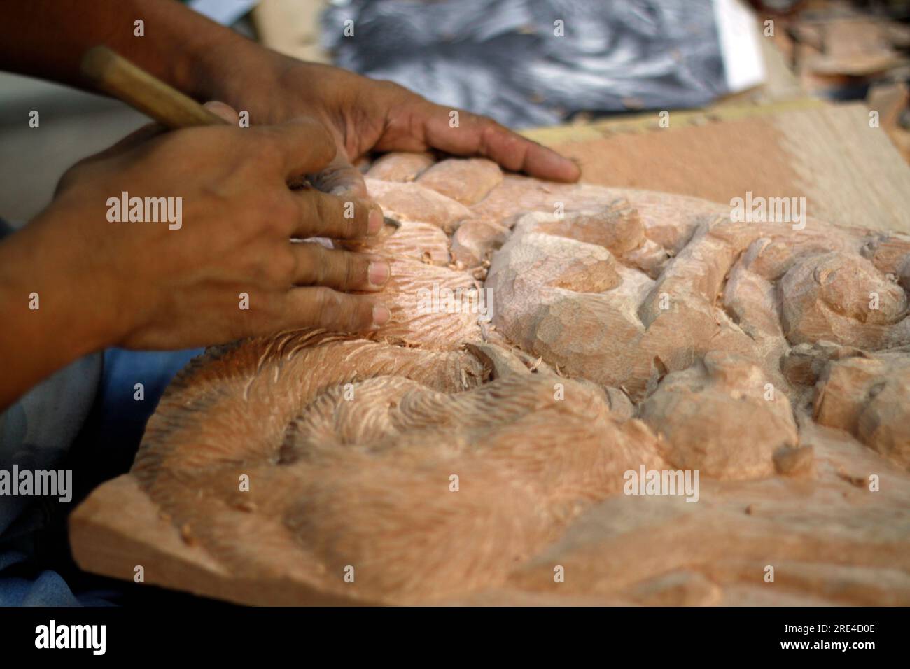 artist making wood carving Stock Photo