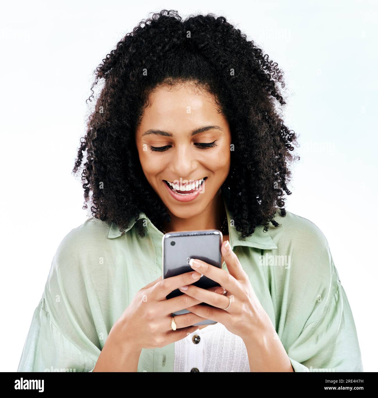 Phone, meme or happy woman texting for gossip or fake news isolated on a white background in studio. Smile, blog search or female person reading post Stock Photo