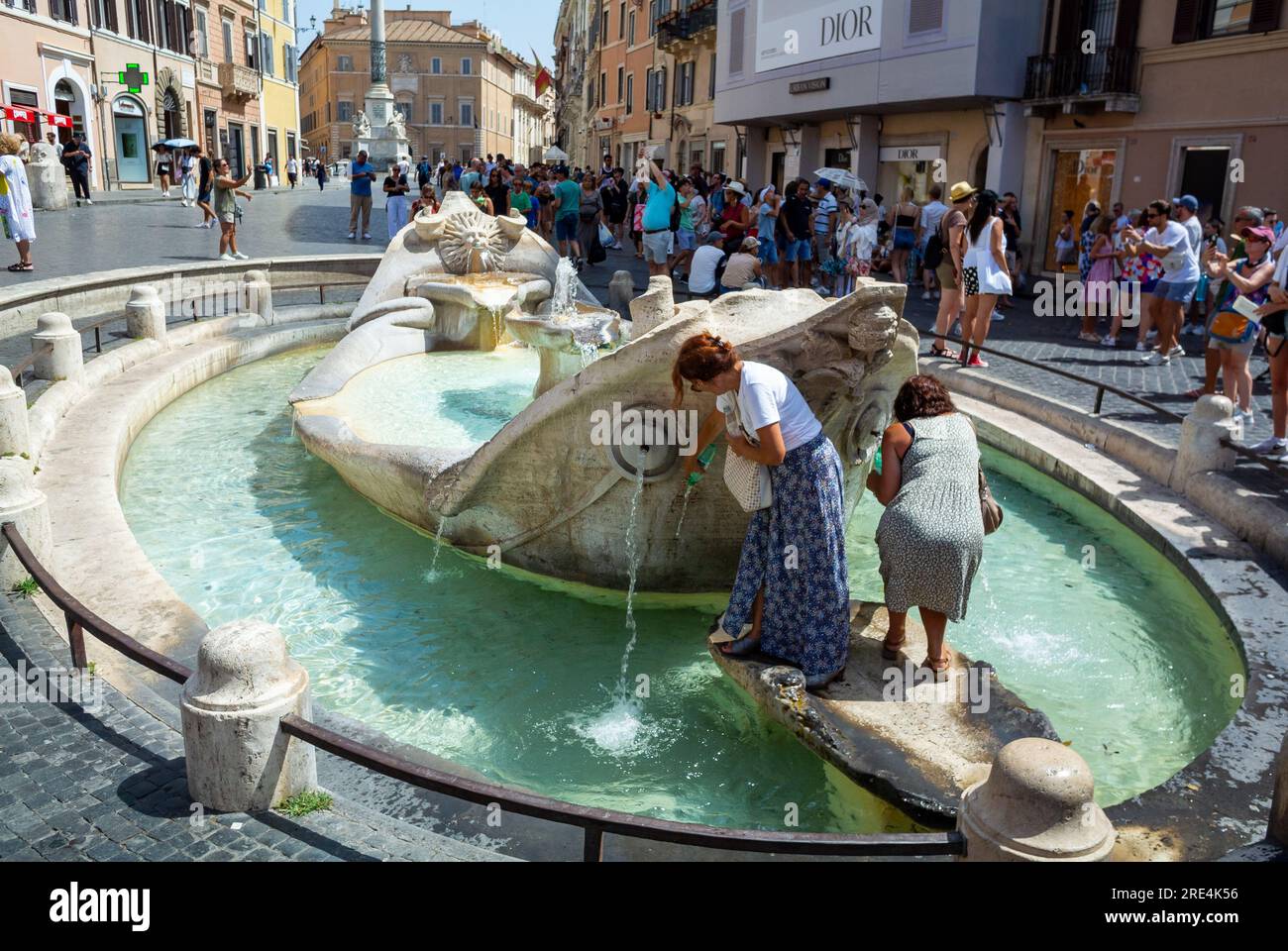 Rome, Lazio, Italy, Tourists collecting water from Fontana della Barcaccia at Piazza di Spagna Stock Photo