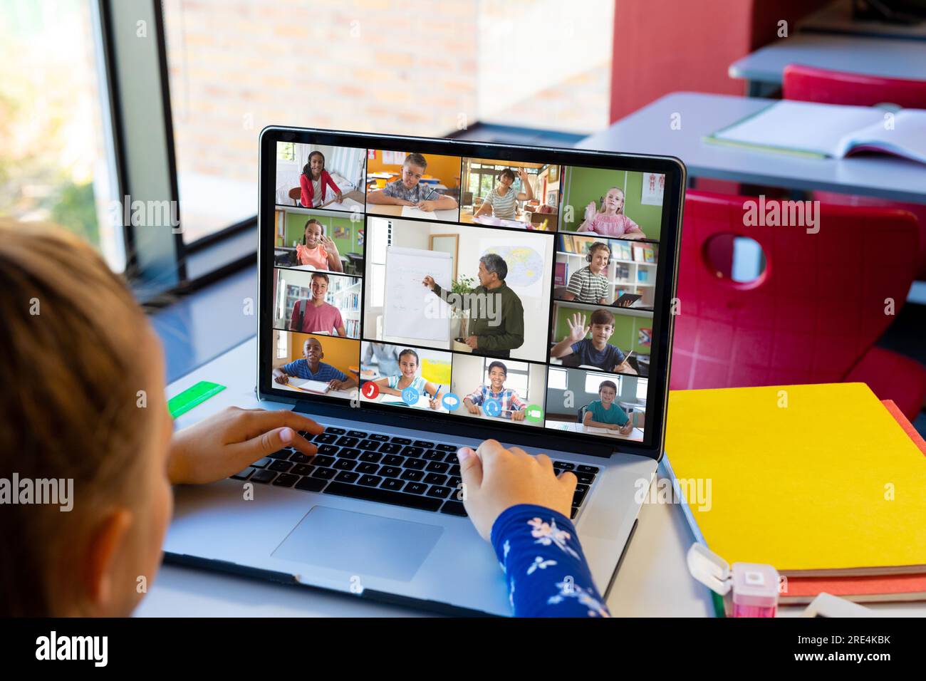 Caucasian girl having a video conference with male teacher and diverse ...