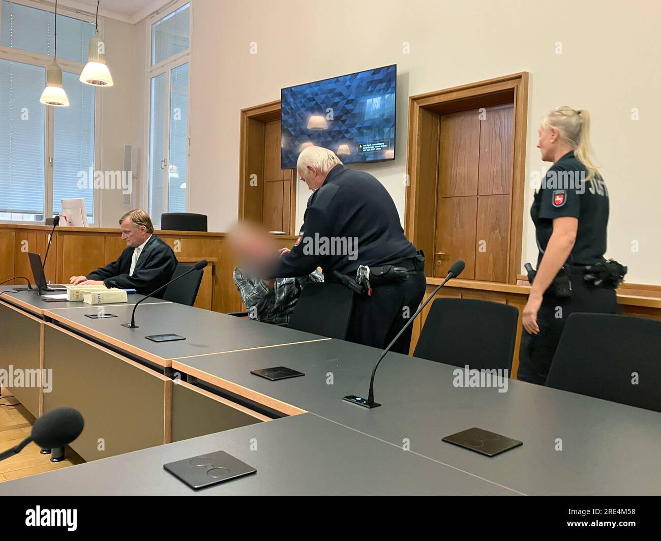 Oldenburg, Germany. 25th July, 2023. An accused man is brought into the