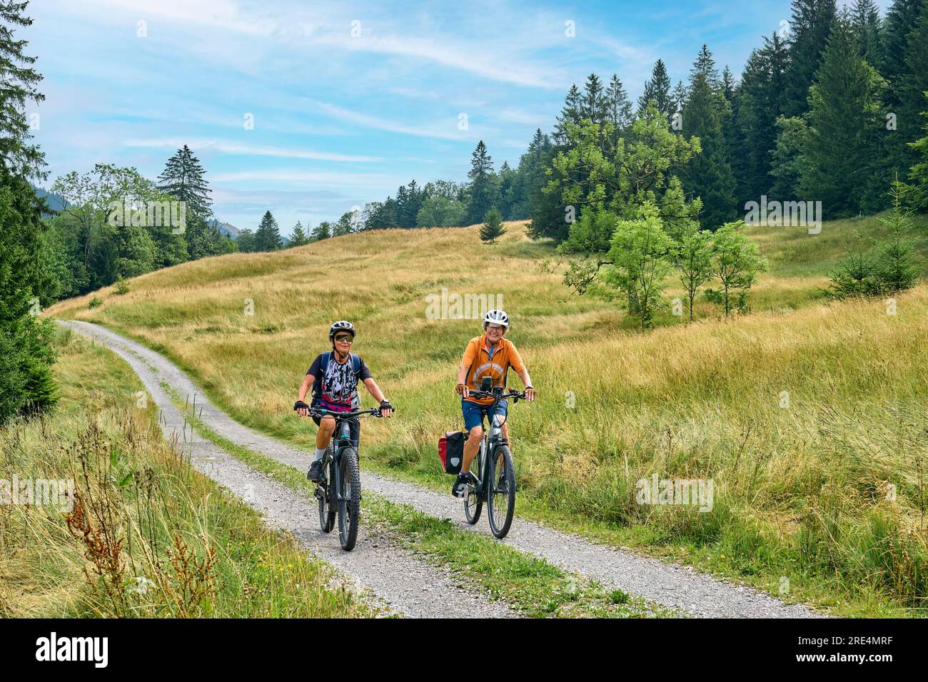 two senior girlfriends having fun during a cycling tour in the Allgau Alps near Oberstaufen, Bavaria, Germany Stock Photo