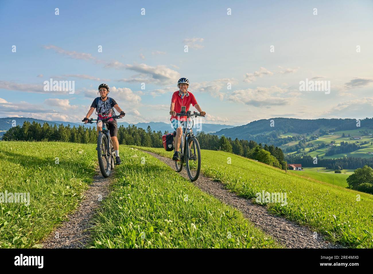 two senior girlfriends having fun during a cycling tour in the Allgau Alps near Oberstaufen, Bavaria, Germany Stock Photo