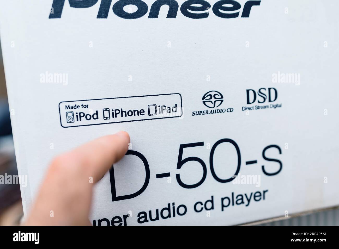 Hamburg, Germany - Jul 24, 2023: Male hand pointing to the Made for iPod iPhone iPad logotype on the new Pioneer PD-50-2 super audio cd SACD player for hifi musicality and audition Stock Photo