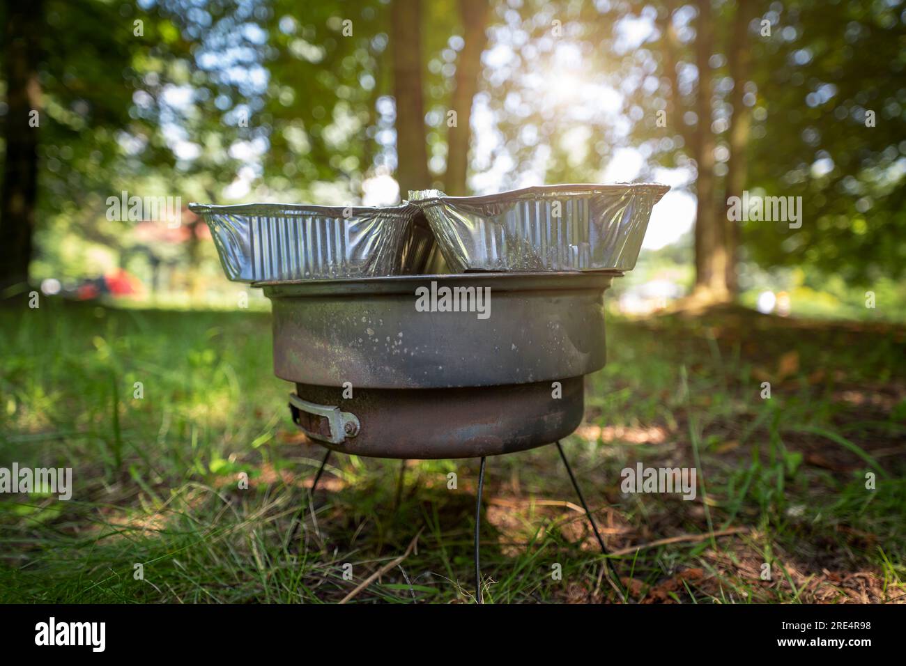 Old small rusty grill spread out on the grass in the park. The perfect