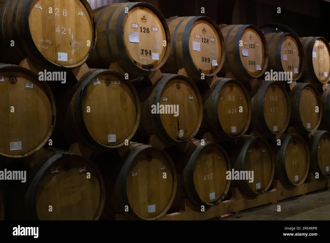 Yerevan, Armenia - May 28 2023: Cellar of the Ararat brandy factory in Yerevan. Close up barrels of cognac in the cellar. Stock Photo