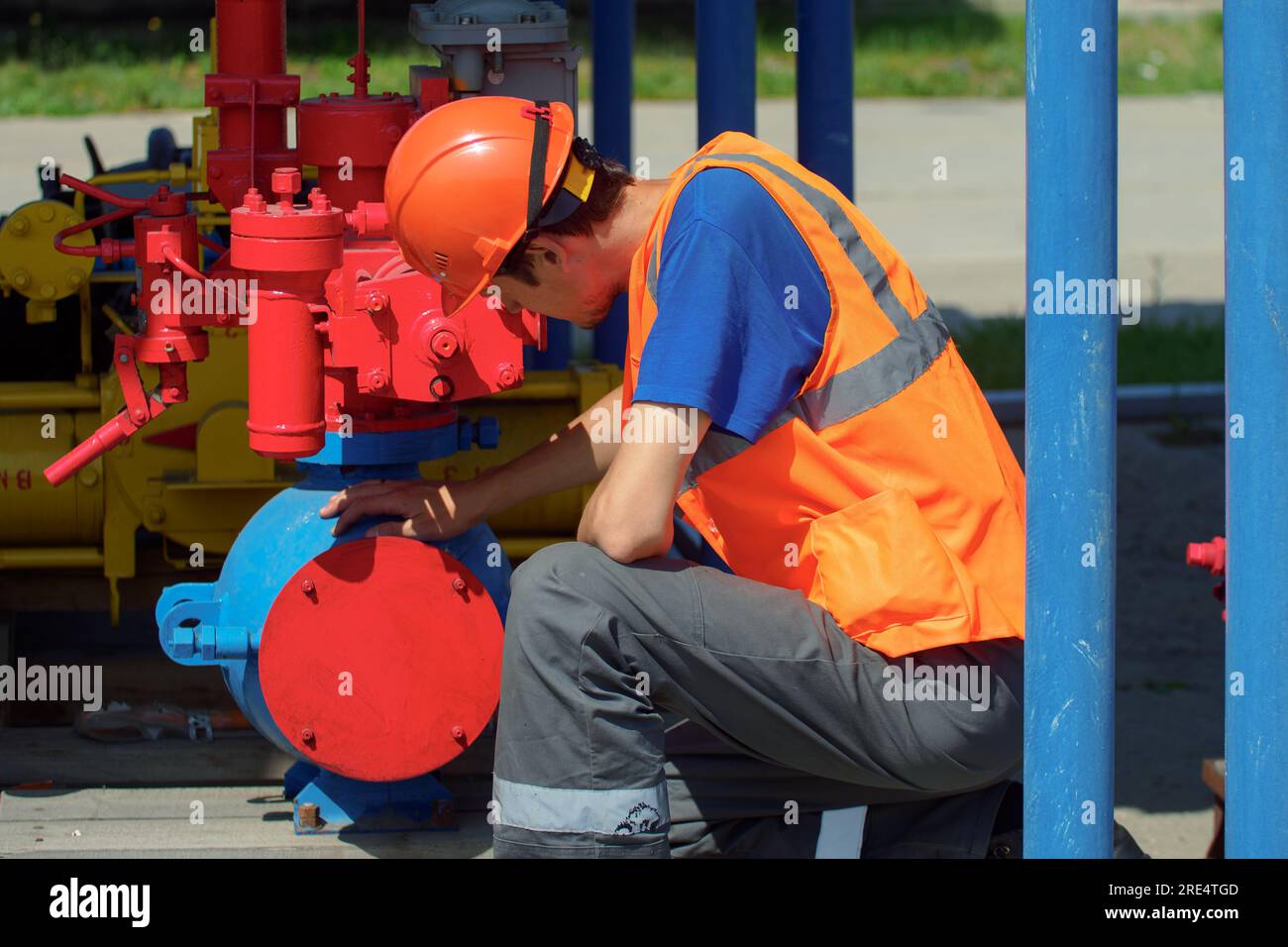 Maintenance of industrial gas equipment. working man in hard hat checks