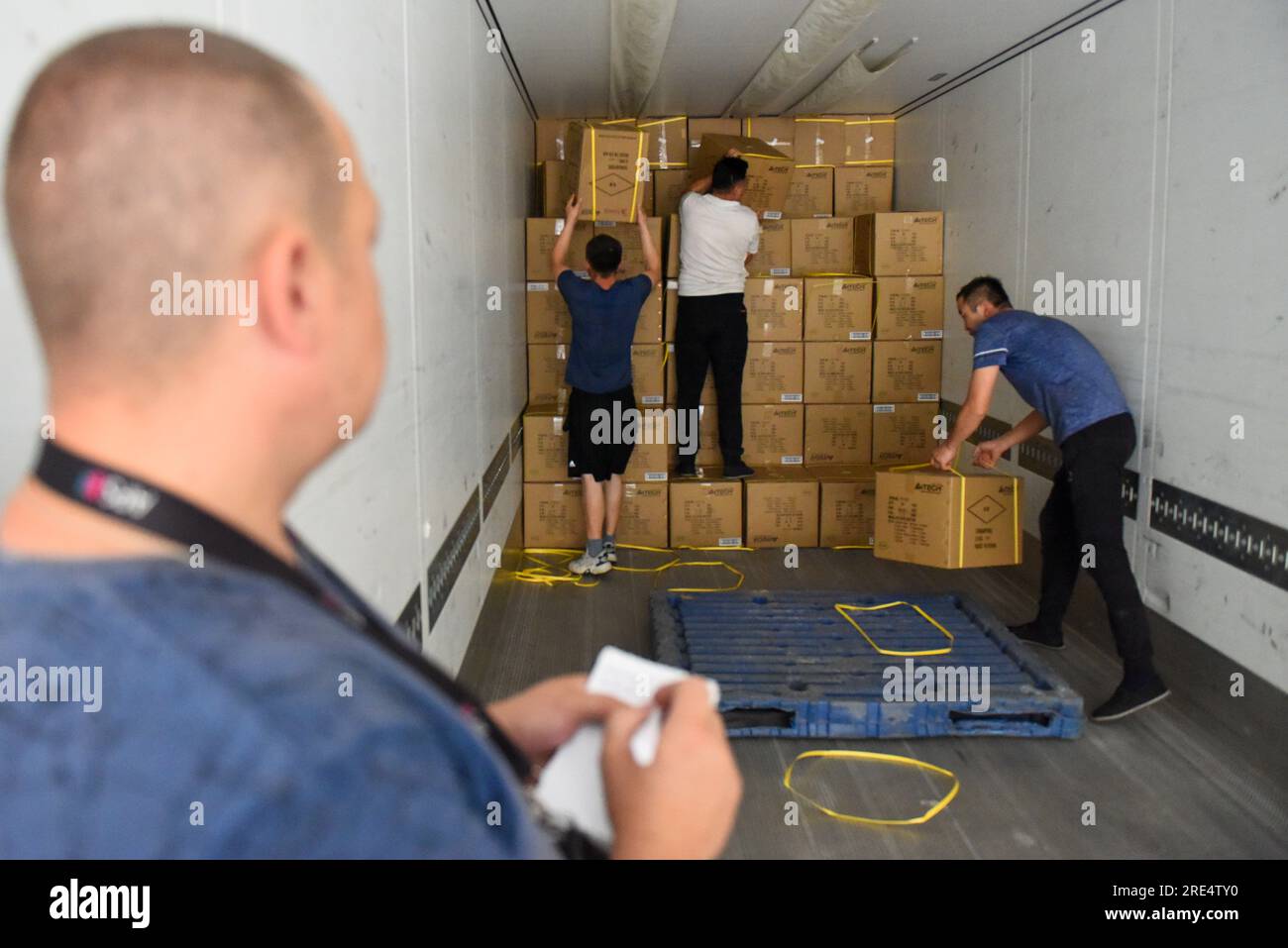 (230725) -- ALATAW PASS, July 25, 2023 (Xinhua) -- Staff members load cargo onto a truck at the custom clearance center for the cross-border e-commerce of the Alataw Pass comprehensive bonded area in northwest China's Xinjiang Uygur Autonomous Region, July 24, 2023. In recent years, various measures have been taken to create a better business environment for cross-border e-commerce enterprises in Alataw Pass. The cross-border e-commerce business was launched in the inland port in northwest China's Xinjiang Uygur Autonomous Region in January 2020. In the first half of this year, more than 14.50 Stock Photo