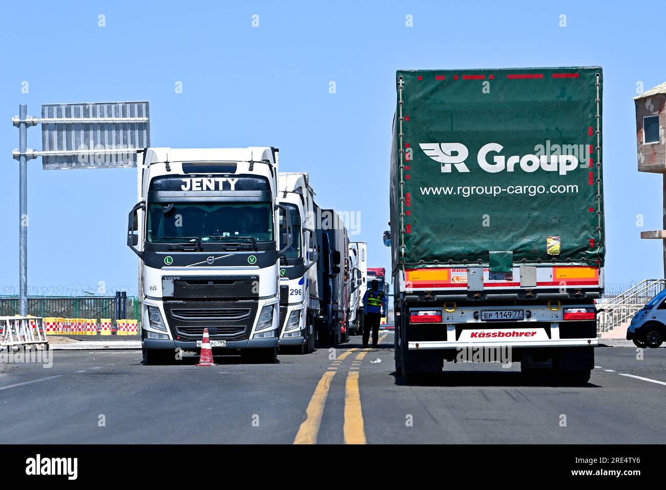 (230725) -- ALATAW PASS, July 25, 2023 (Xinhua) -- Cargo trucks are pictured at the Alataw Pass in northwest China's Xinjiang Uygur Autonomous Region, July 24, 2023. In recent years, various measures have been taken to create a better business environment for cross-border e-commerce enterprises in Alataw Pass. The cross-border e-commerce business was launched in the inland port in northwest China's Xinjiang Uygur Autonomous Region in January 2020. In the first half of this year, more than 14.50 million cross-border e-commerce packages worth about 1.677 billion yuan (about 235 million U.S. doll Stock Photo