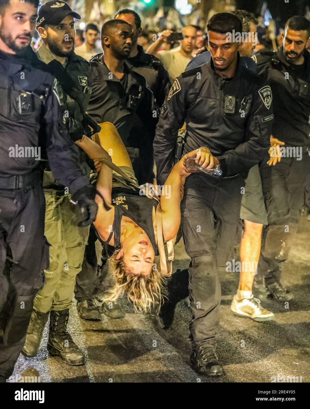Jerusalem, Israel. 24th July 2023.  Police officers are carrying  a woman protester, taking her into custody   Credit: Yoram Biberman/Alamy Live News. Stock Photo