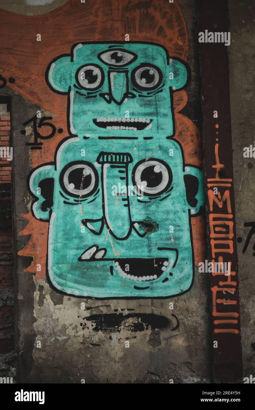 blue two head elephant graffiti art iece on brick wall with pipes Stock Photo