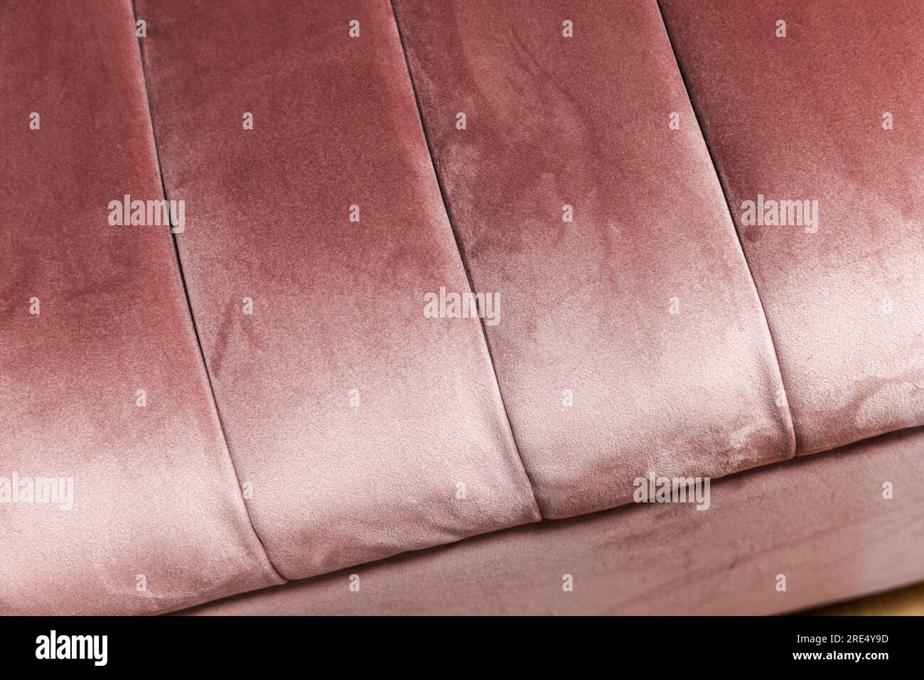 Pink flocking fabric of sofa pillows, close up background photo Stock Photo