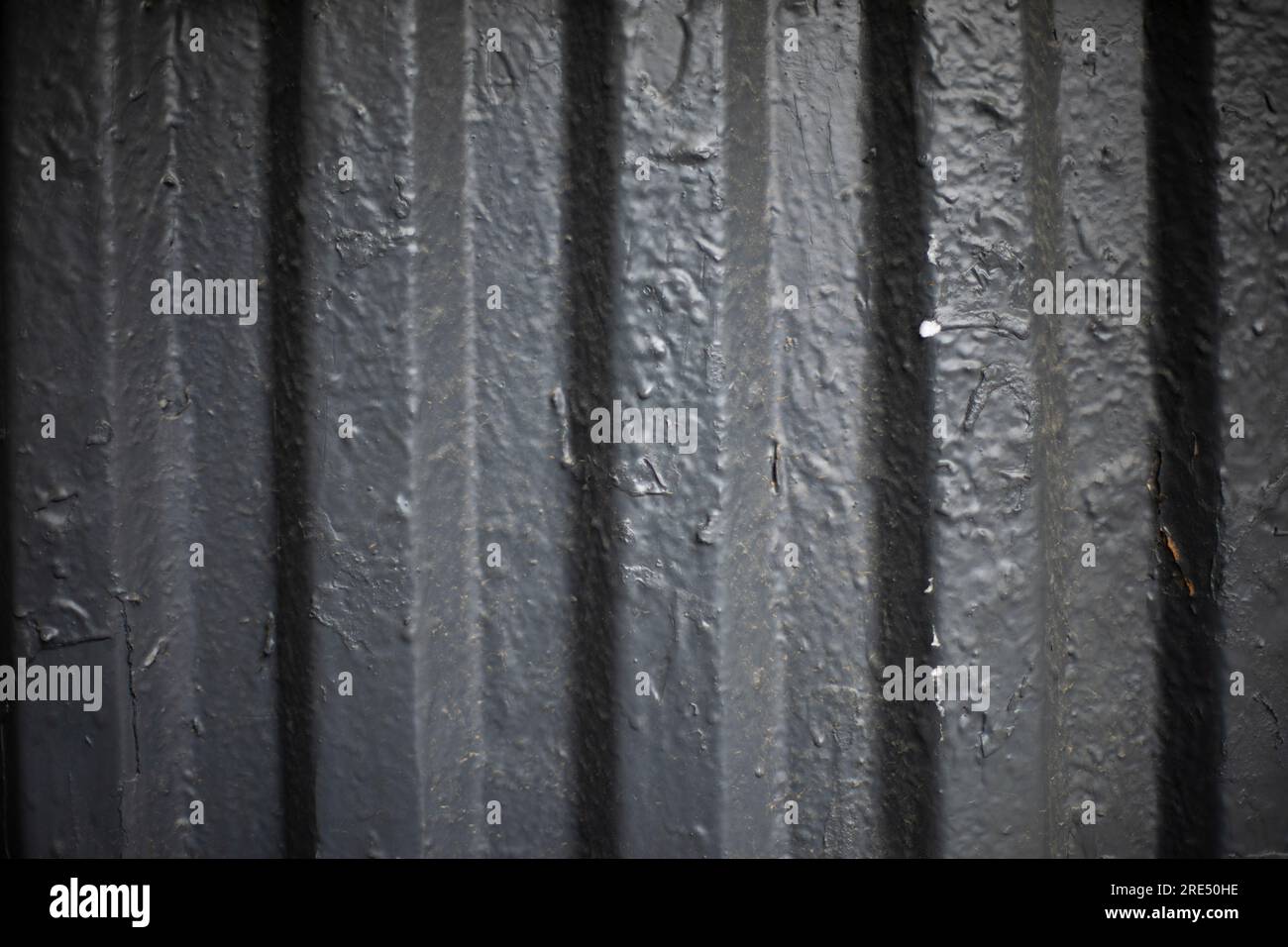 Gray paint on fence. Thick coat of paint. Steel surface. Grey