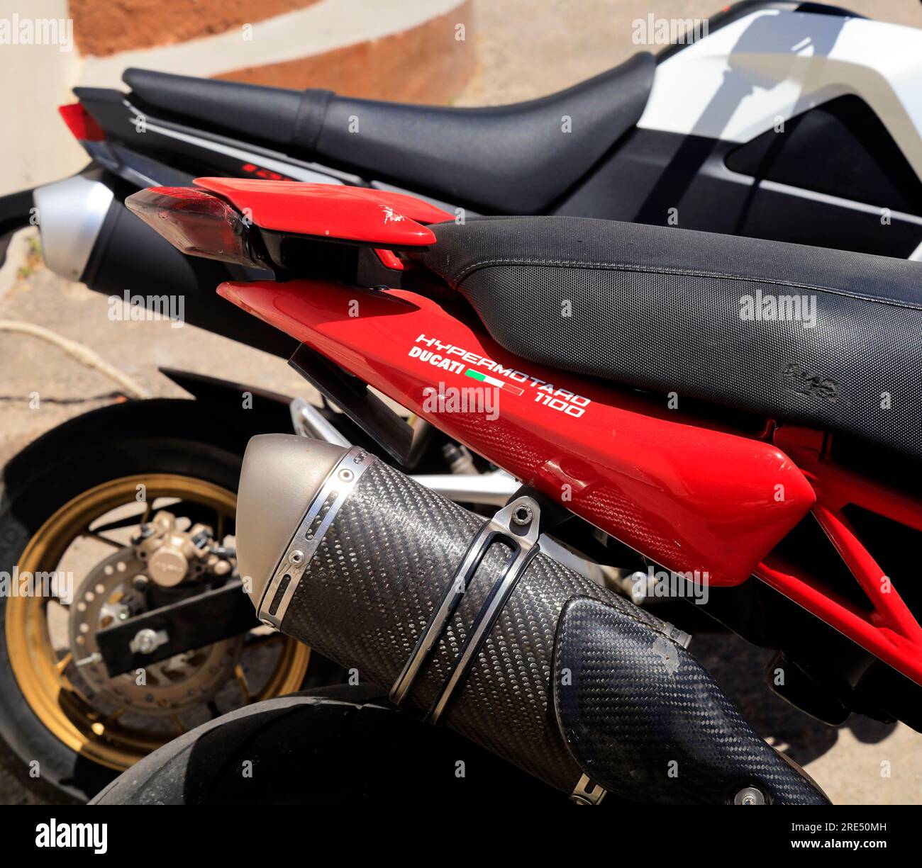 Detail of model, Red Ducati motor cycle parked by the roadside, Hypermotard  1100. Tilos island, near Rhodes, Dodeanese, Greece Stock Photo - Alamy