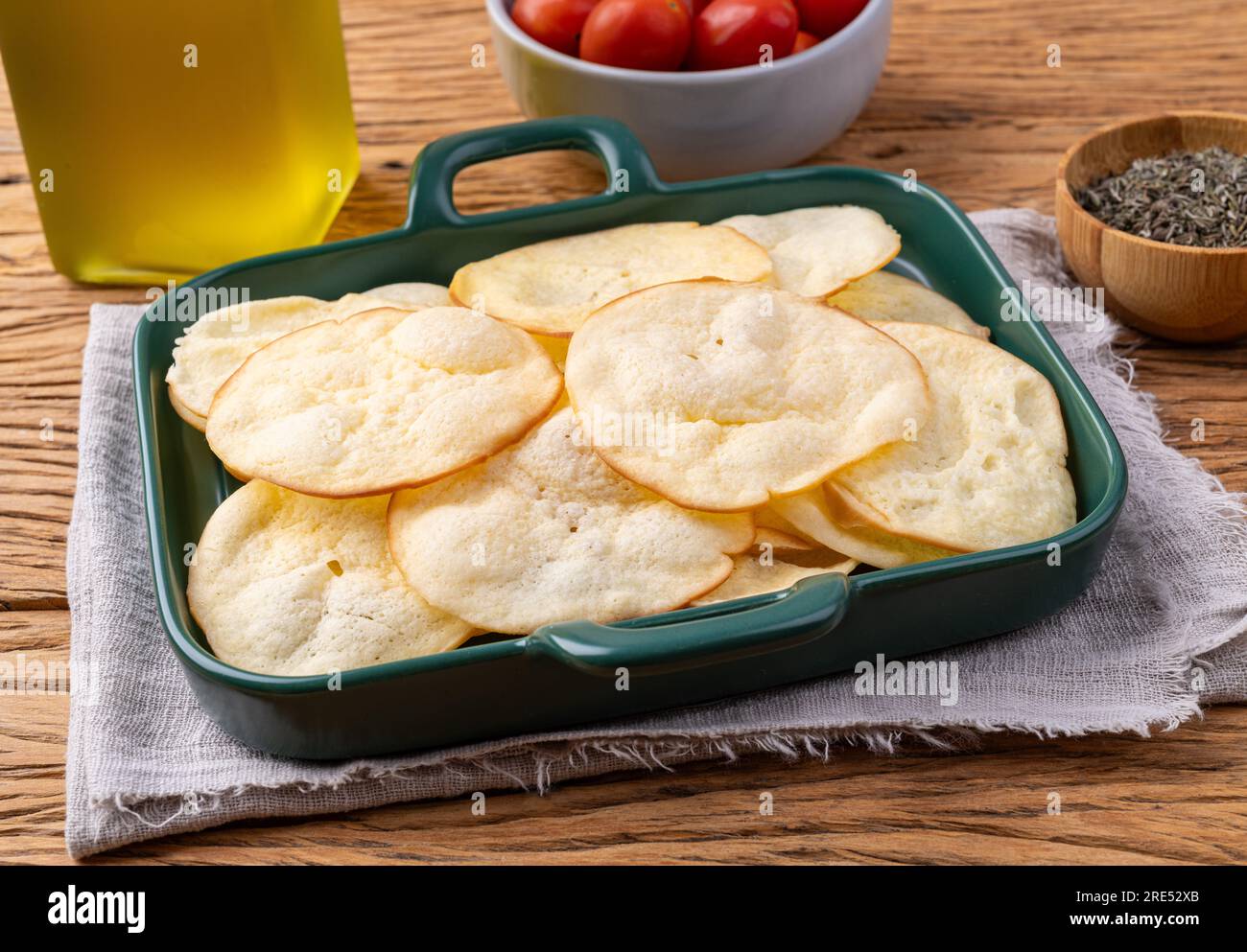 Smoked provolone cheese chips in a bowl with cherry tomatoes and