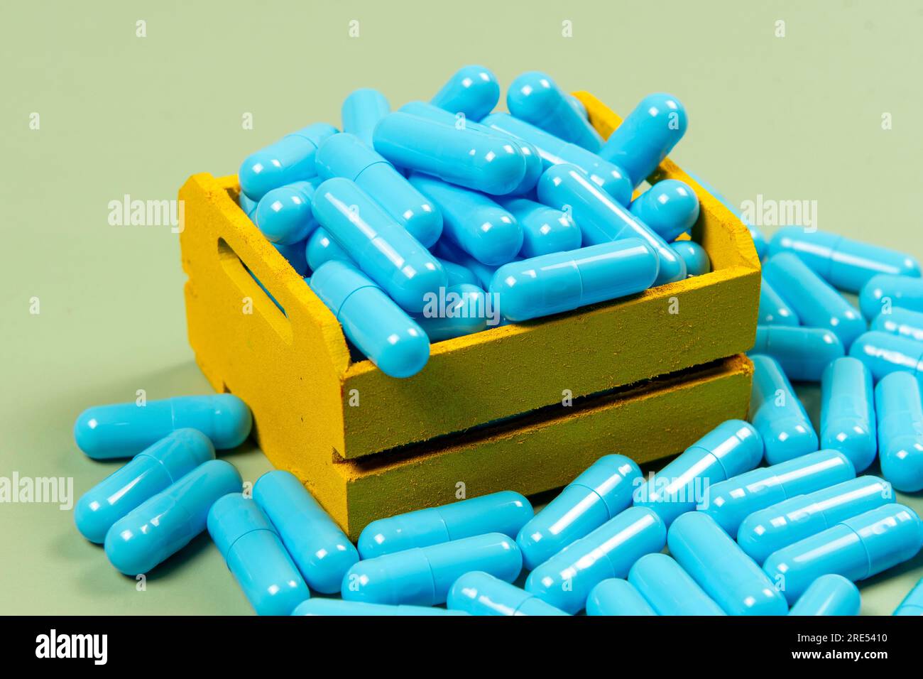 blue medicine capsule in yellow delivery box Stock Photo Alamy