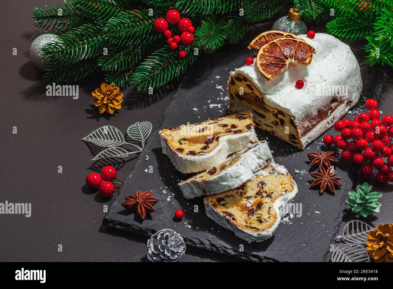 Traditional Christmas stollen, German cake. European pastry, fragrant home  baked bread with spices and dried fruit. Xmas tree branches and decorations  Stock Photo - Alamy