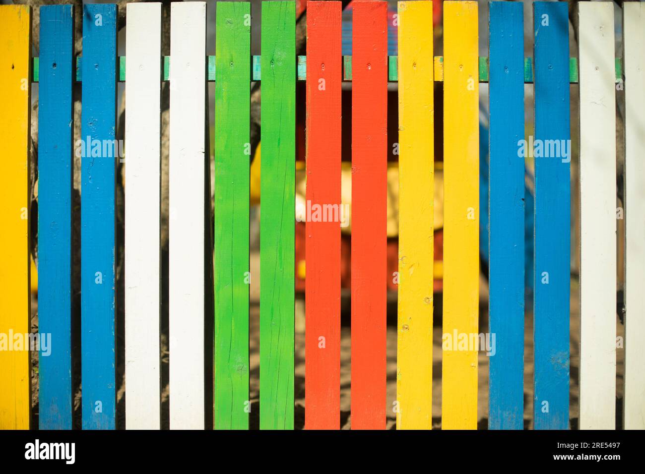 Colored fence. Beautiful fence. Different color on boards. Painted ...