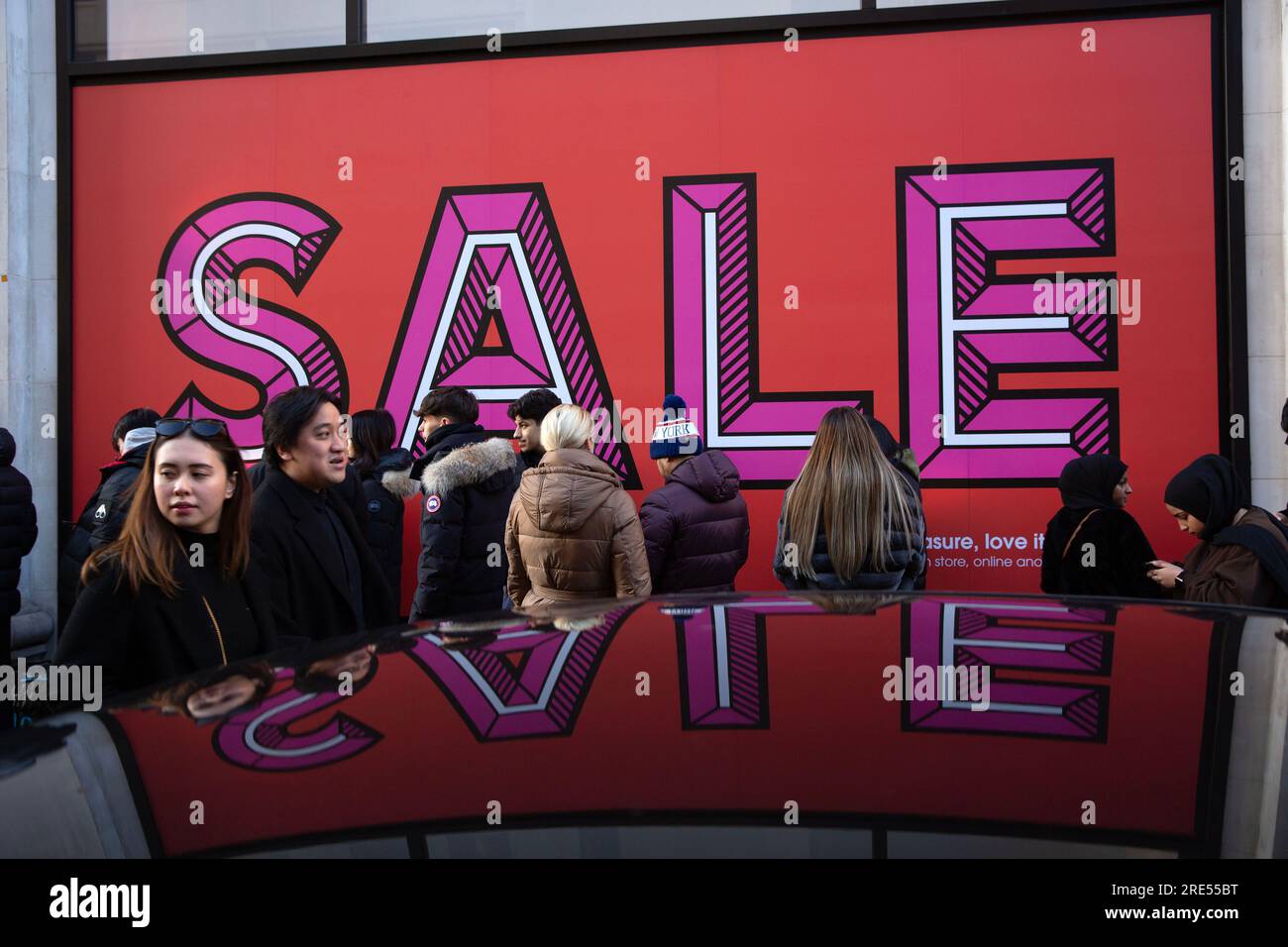 People wait outside Selfridges store on Oxford Street in London, ahead