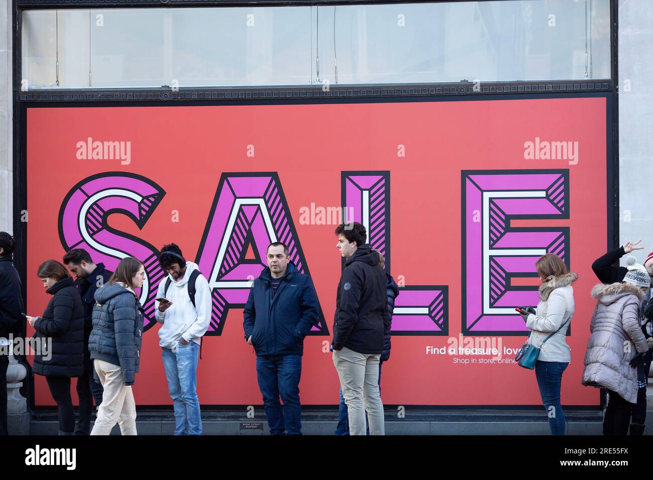 People wait outside Selfridges store on Oxford Street in London, ahead