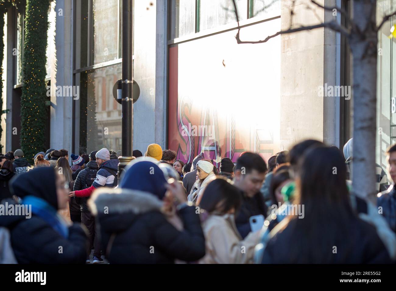 People wait outside Selfridges store on Oxford Street in London, ahead
