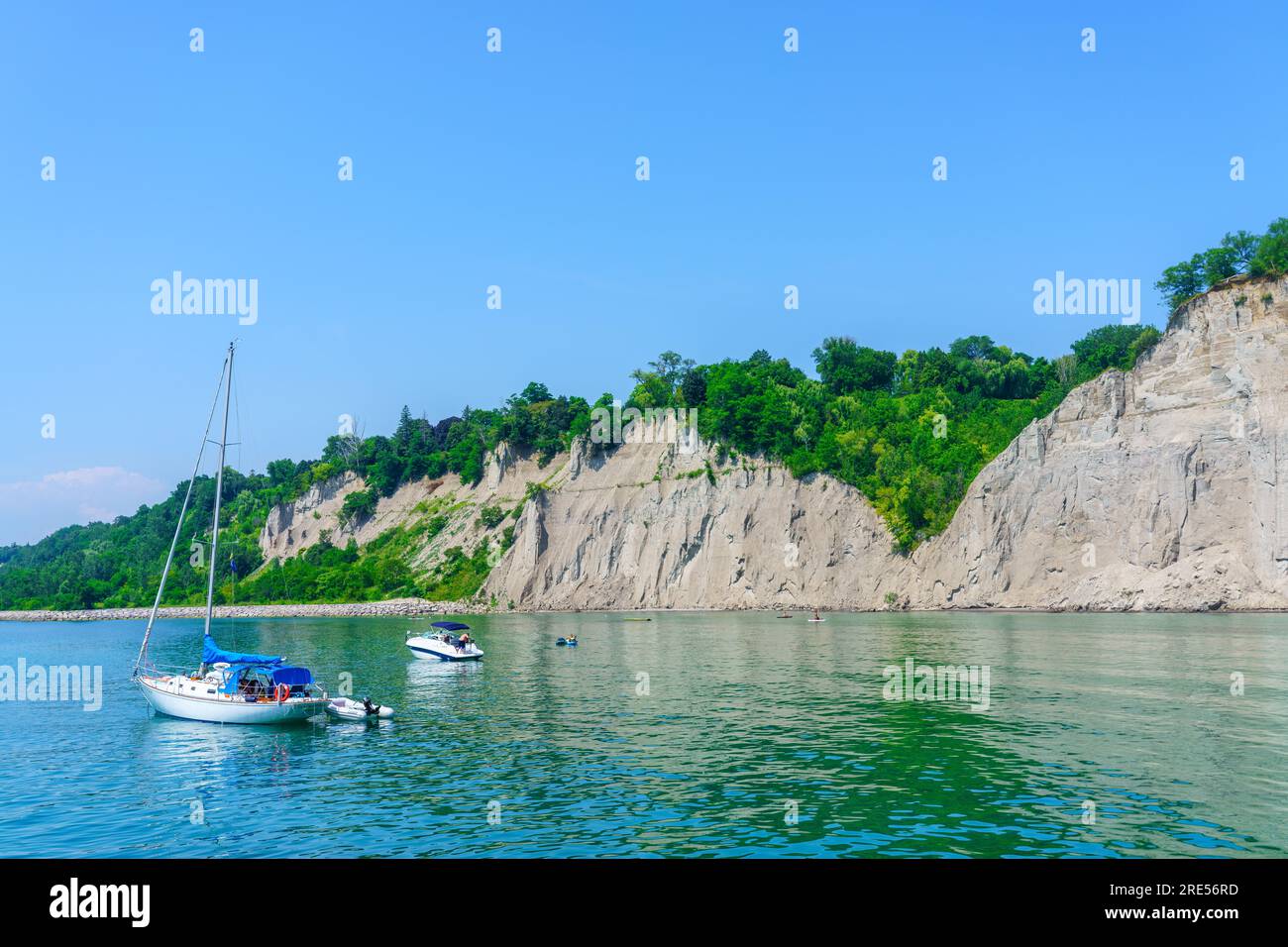 Toronto, Canada - July 23, 2023: Small recreation yachts moored by the Scarborough Bluffs. It is a beautiful blue sky Summer day. Stock Photo