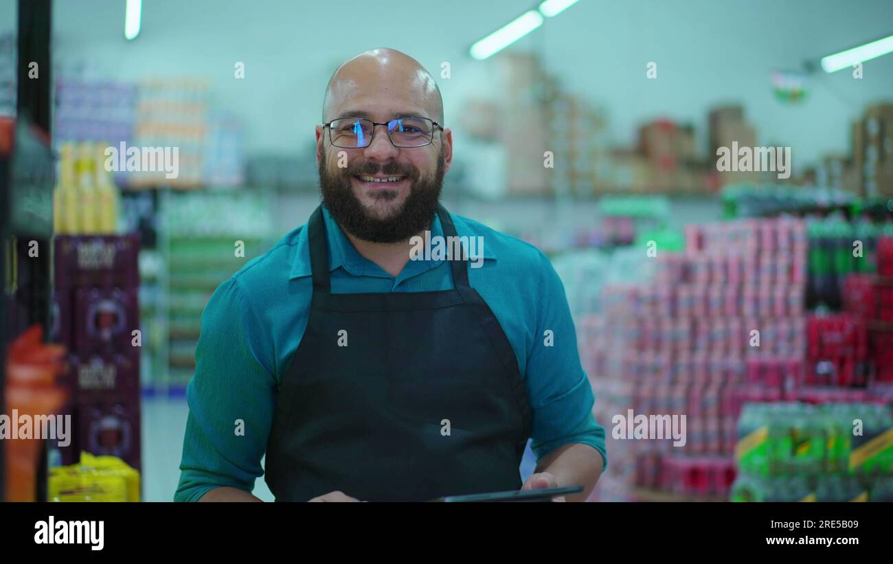 Joyful employee of Grocery store portrait smiling at camera standing in ...