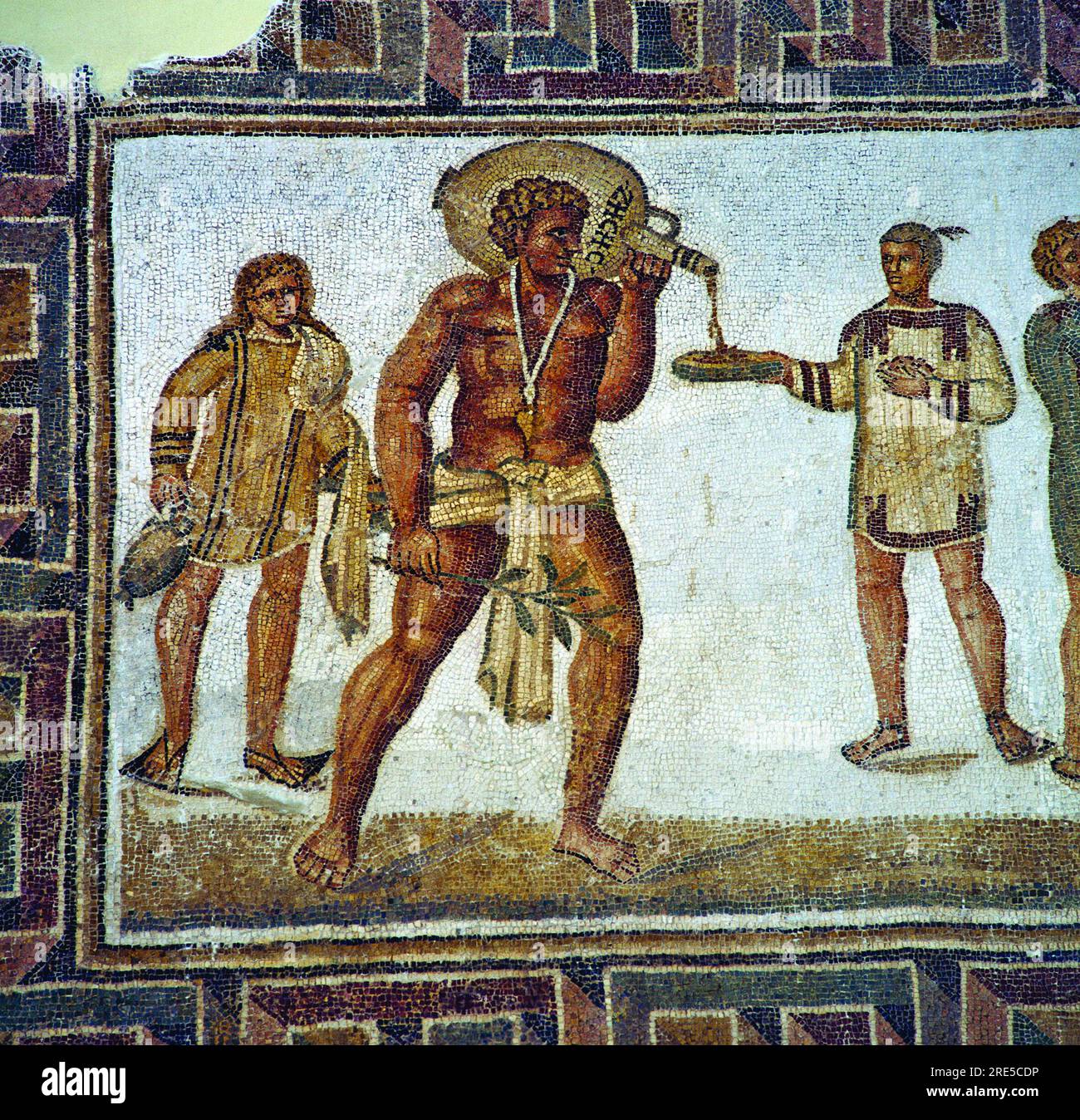 Title: Slave pouring something to drink, from the Butlers mosaic from Thugga, Dougga, Tunisia Creator: Unknown (Artwork from ancient times) Date: Believed to be from the 2nd or 3rd century AD (Ancient Roman period) Dimensions: Not specified  Medium: Mosaic (Tiles) Location: Thugga (Dougga), Tunisia (Ancient Roman city, now an archaeological site) Stock Photo