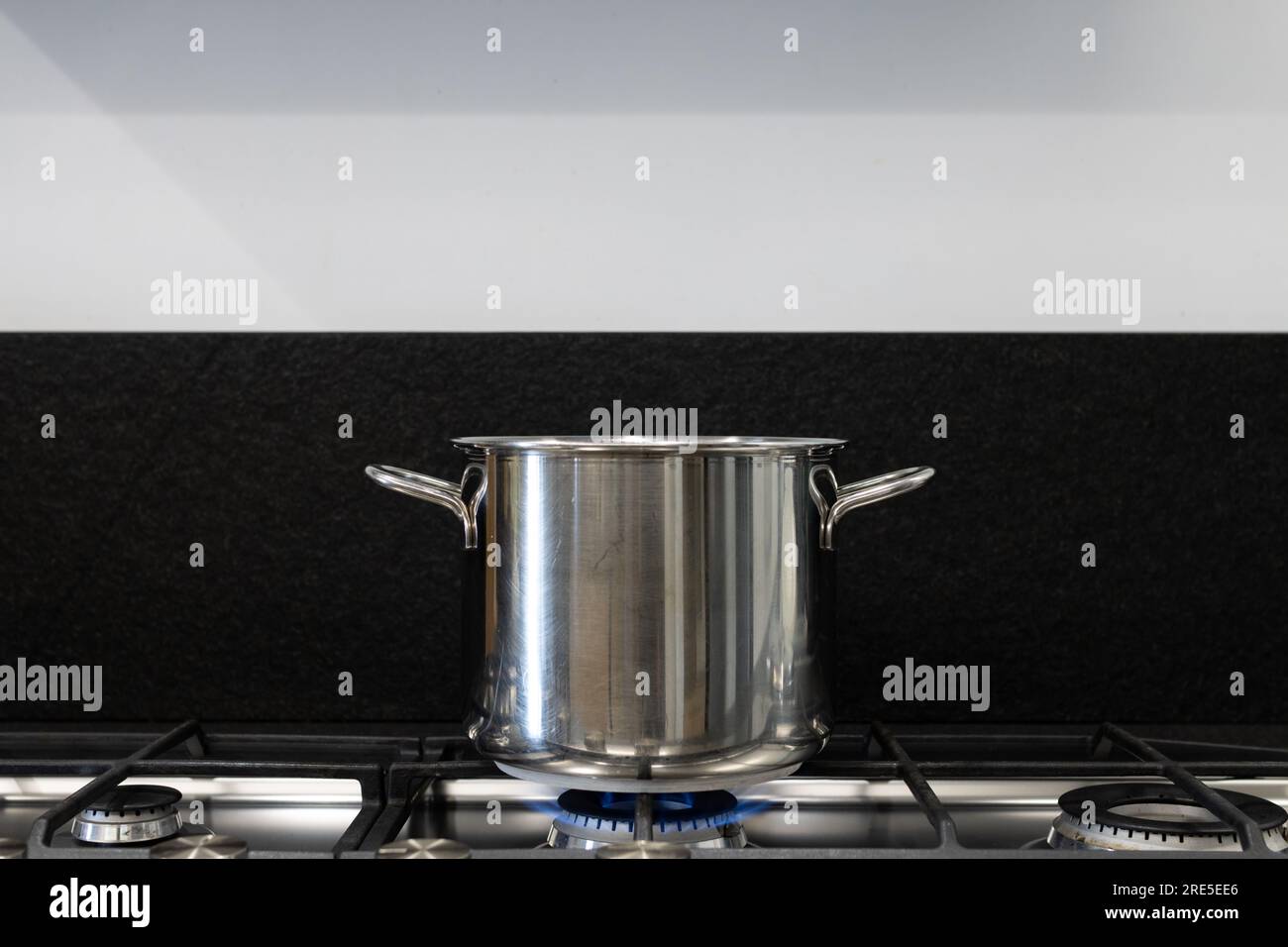 Steel pot on the fire of a gas stove in the kitchen. Concept for the