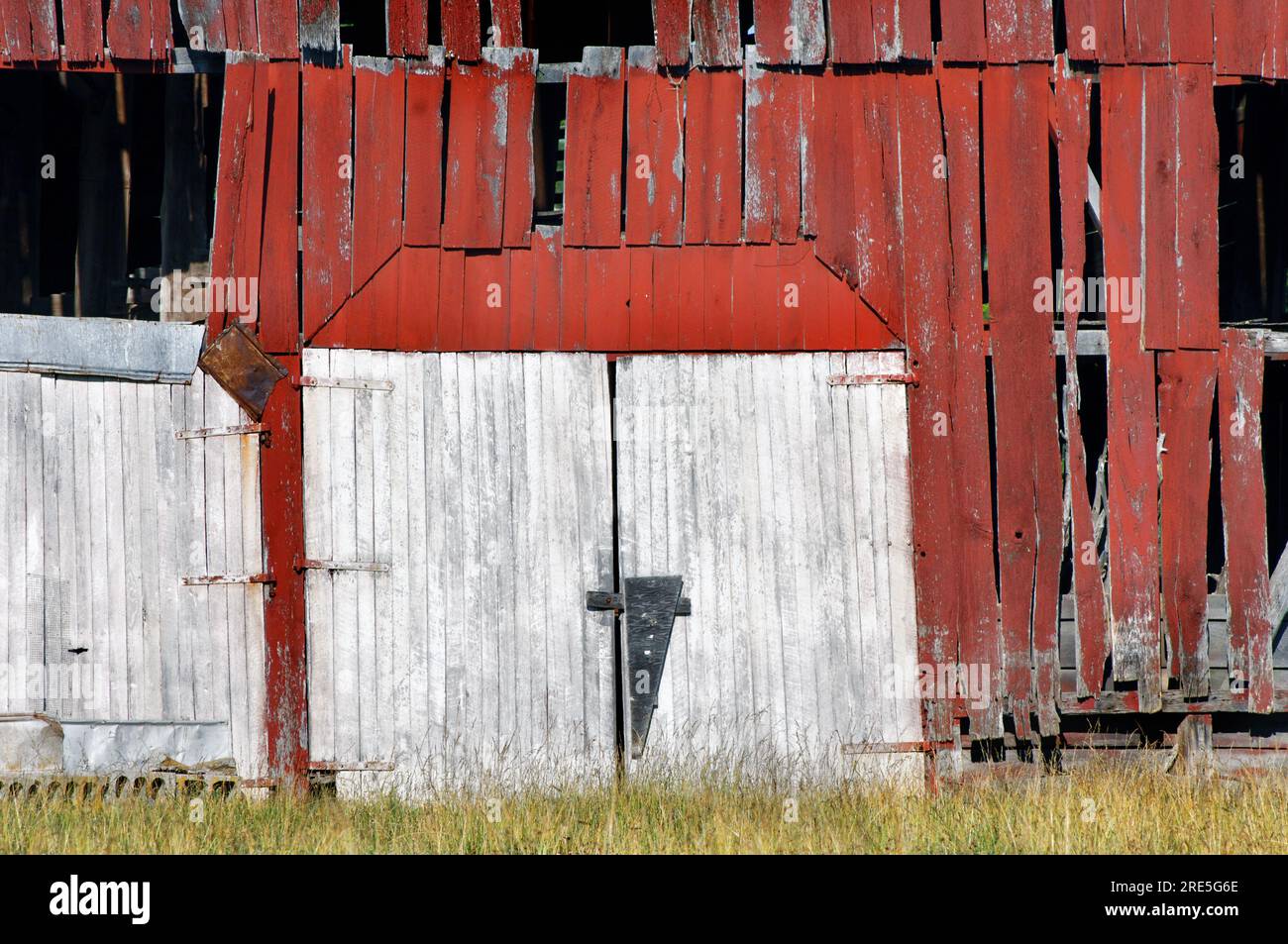 Double barn doors are boarded shut and historic building is abandoned