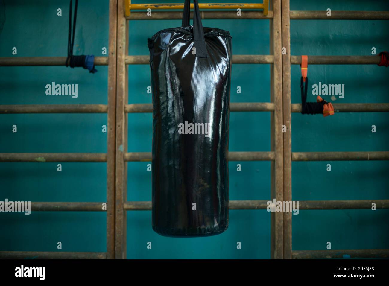 Punching bag in gym. Black punching bag for punch training. Sports
