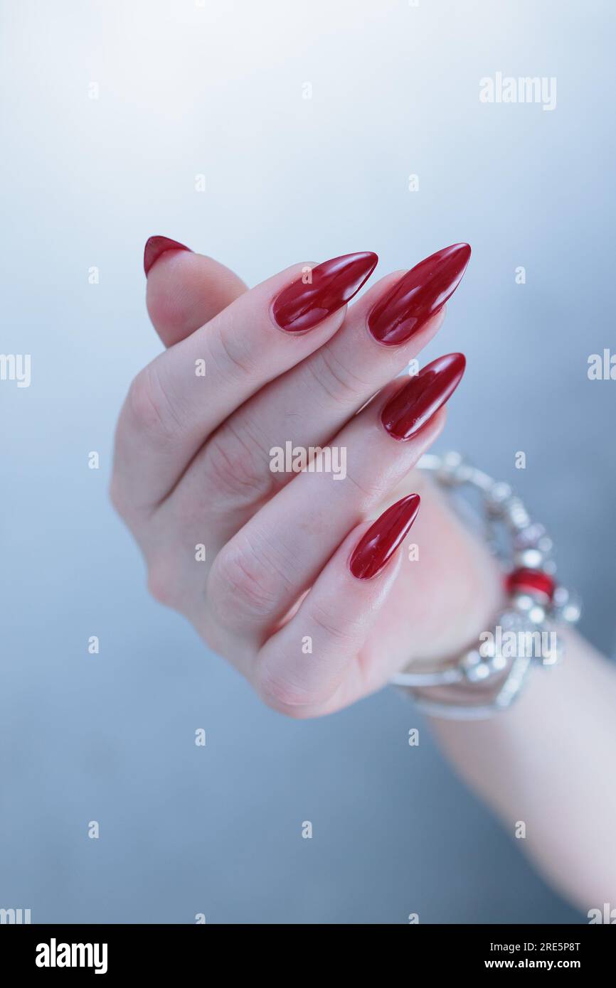 Photo of Woman Hands with Fancy Nail Polish and Red Lips | Stock Image  MXI23952