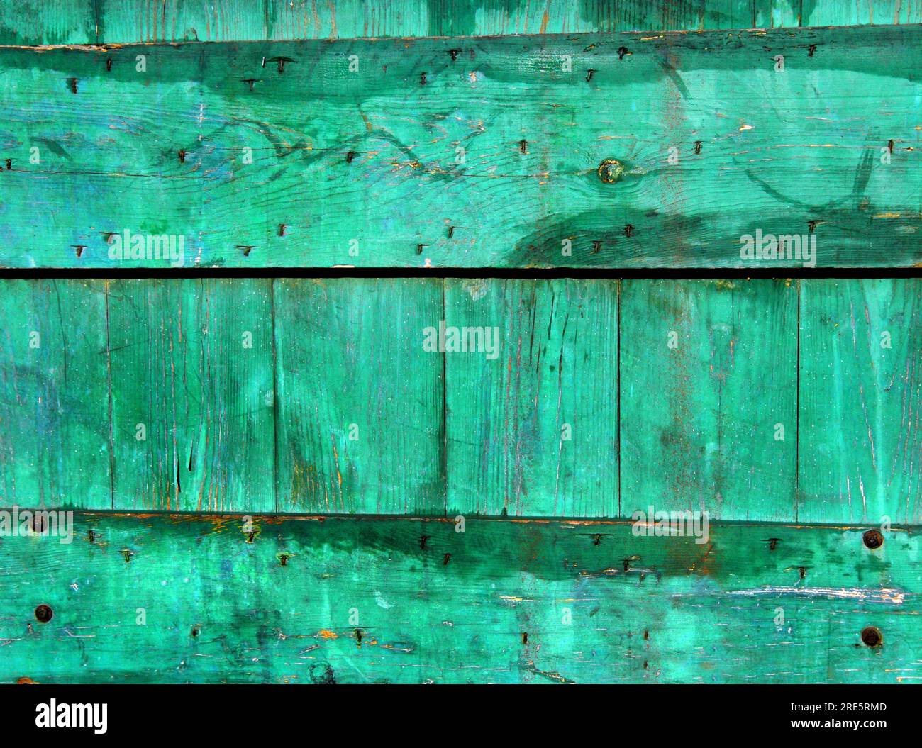 Background image shows weathered wooden gate painted green. Nails are