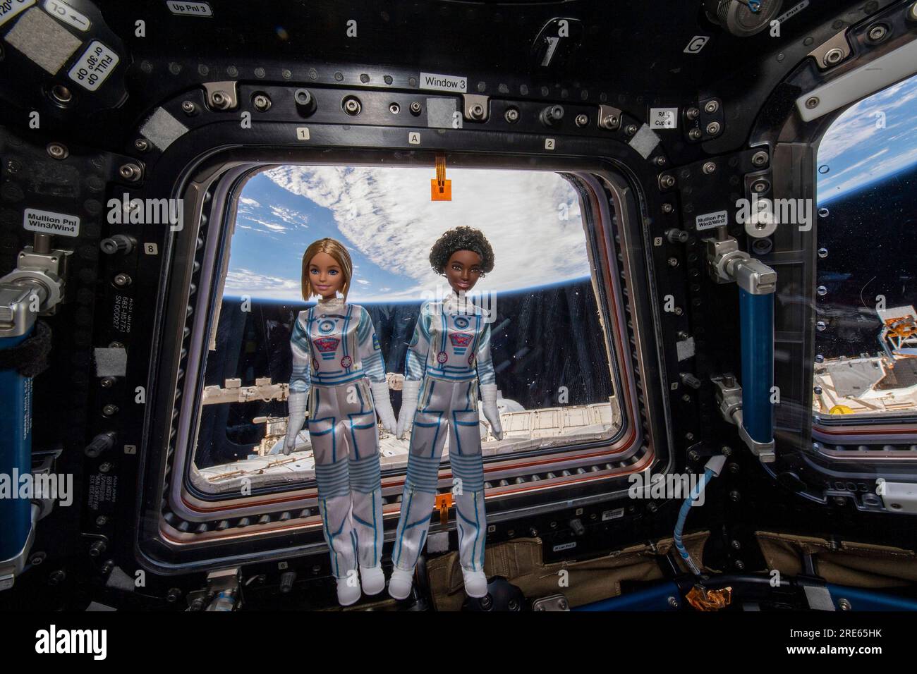 International Space Station, Earth Orbit. 14 April, 2022. Two Barbie dolls with the Mattel Space Discovery line wearing white spacesuits with pink and blue detailing float in microgravity inside the Cupola of the International Space Station, April 14, 2022 in Earth Orbit. The journey of Barbie into space was part of Mission DreamStar, an educational outreach project by Mattel that introduces young girls to careers in STEM fields. Credit: International Space Station/NASA/Alamy Live News Stock Photo