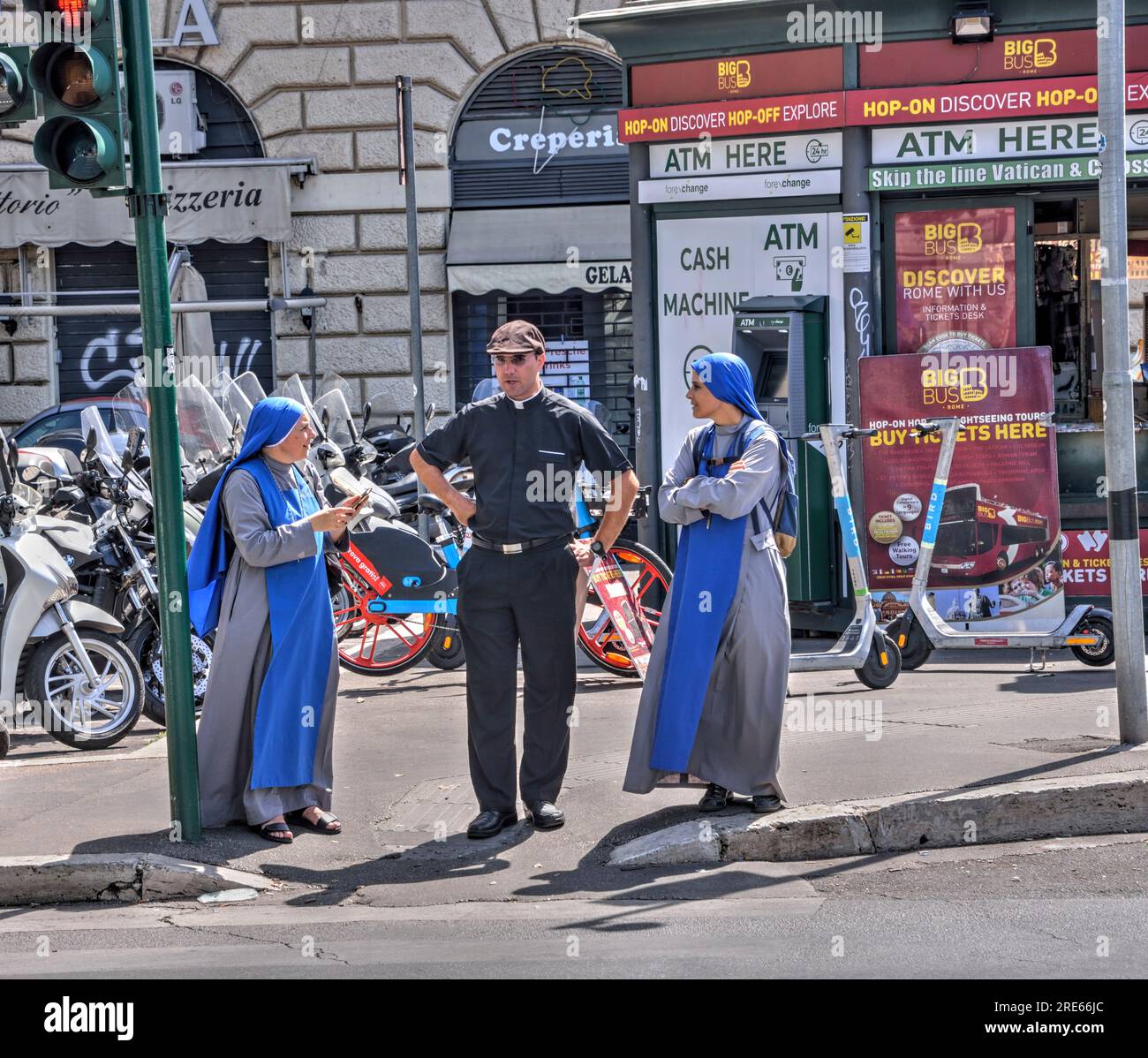 Rome, Italy - September 2, 2022: A Catholic priest and two nuns wait to cross the street in Rome, Italy. Editorial. Stock Photo