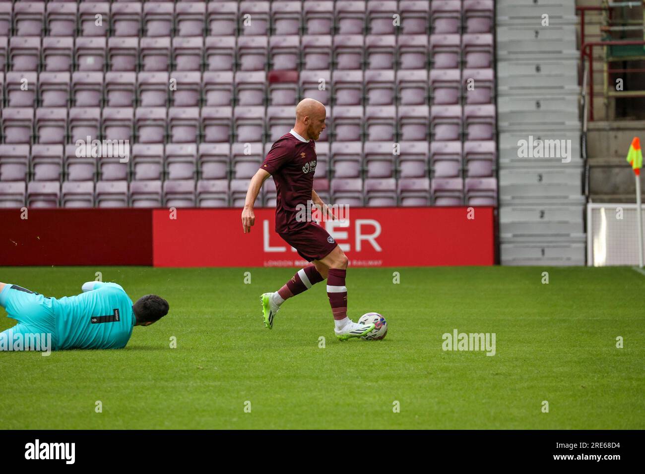 Tynecastle Park. Edinburgh, UK. 25th July, 2023. During the closed doors friendly between Heart of Midlothian FC and Mansfield Town FC Hearts Liam Boyce opens the scoring ( Credit: David Mollison/Alamy Live News Stock Photo