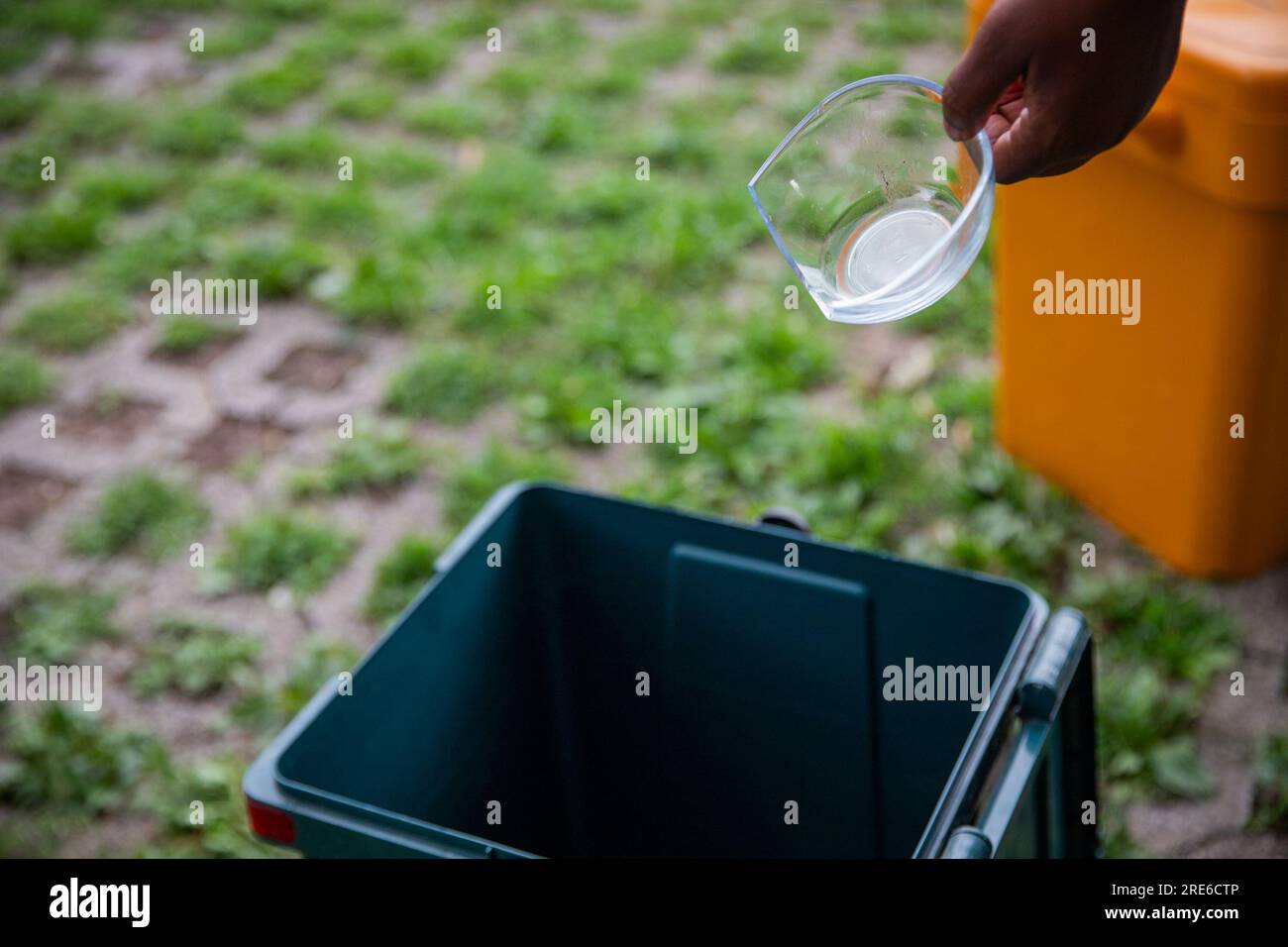 A woman throws a broken glass bowl into a glass collection bin, waste sorting Stock Photo Alamy