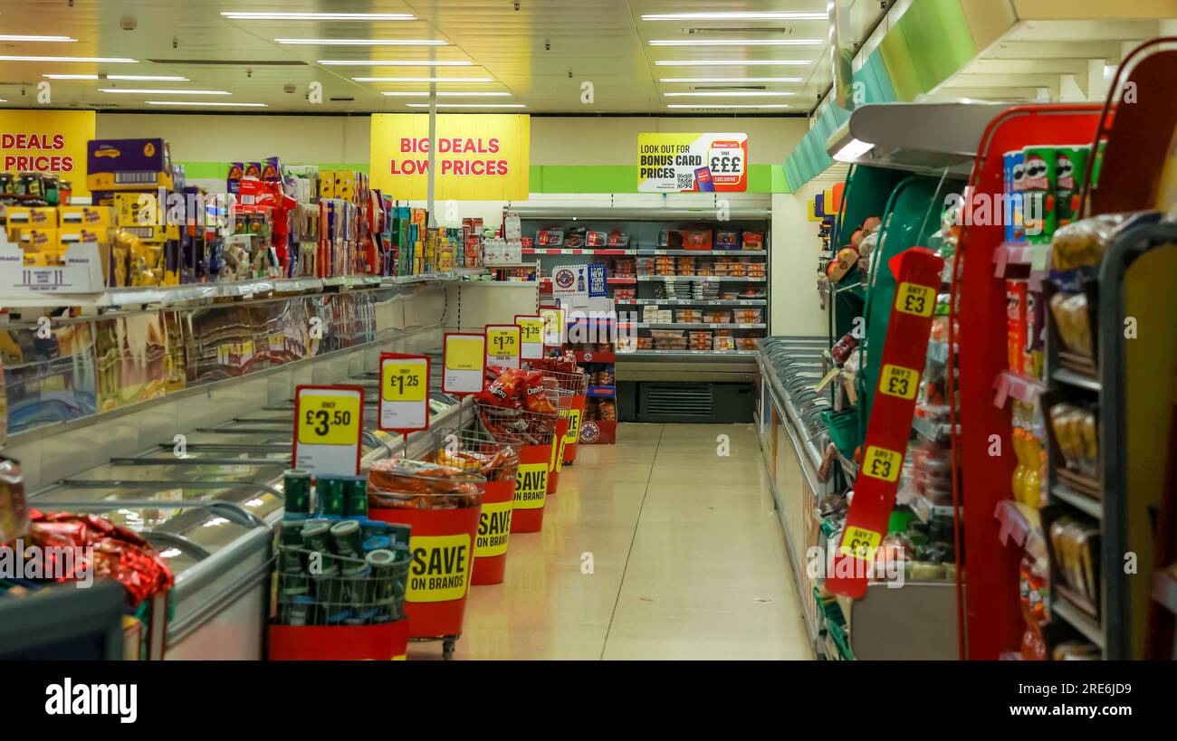 Interior UK frozen food retailer outlet, view down aisle of an Iceland retail store chain supermarket in UK with grocery pricing and deals on display. Stock Photo