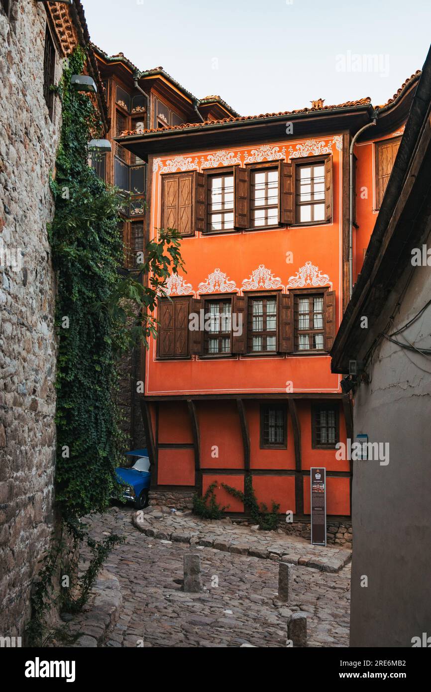 The Historical Museum in old town Plovdiv, Bulgaria. Featuring Revival Bulgarian architecture painted in a vibrant orange color Stock Photo