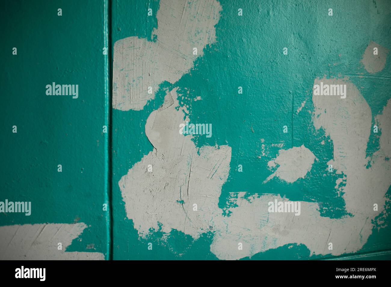 Repairing wall. White spots on green. Wall alignment. Paint application